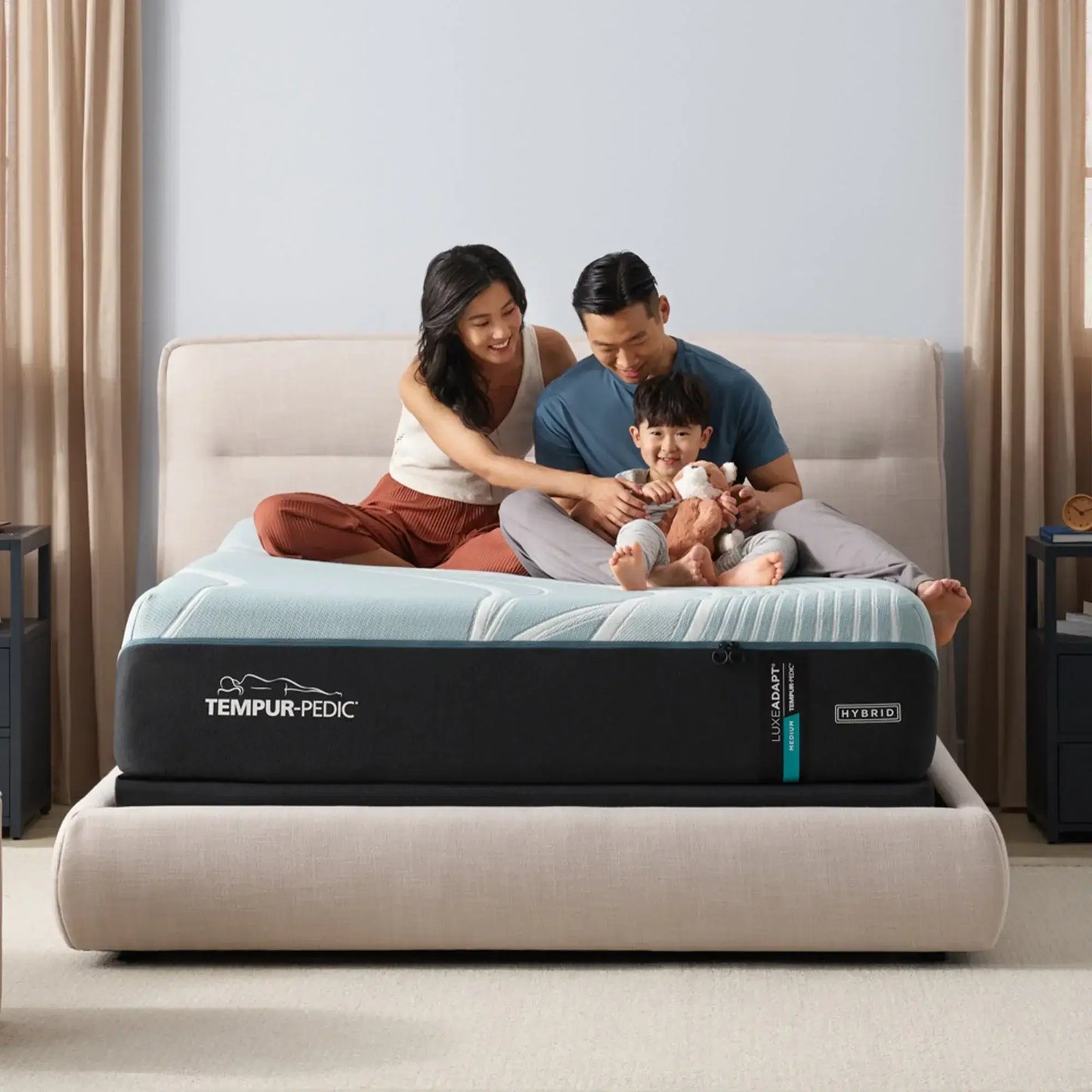 Family enjoying quality time on a Tempur-Pedic TEMPUR-LuxeAdapt® 13" Medium Hybrid Mattress in a cozy bedroom setting.