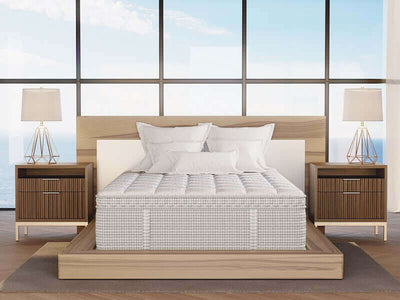 Luxurious Lucille mattress on a modern wooden bed frame with nightstands and lamps, set against a scenic window view.