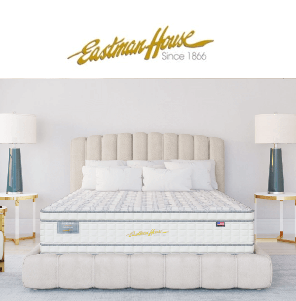 Eastman House mattress on a stylish bed, featuring elegant lamps and a modern bedroom design.