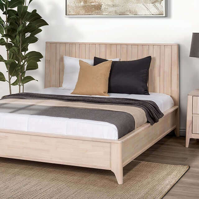Gervais Mid Century Bed with white washed wood frame, featuring vertical reeding and stylish decorative pillows.