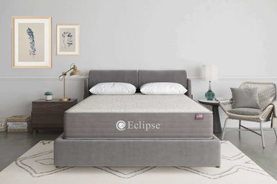 Eclipse Cares Collection Kindness Hybrid 13" Firm Mattress displayed in a modern bedroom setting with stylish decor.