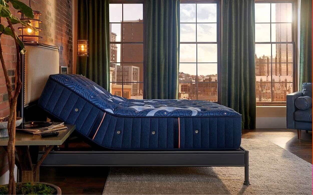Luxurious Stearns & Foster 14.5" Ultra Firm mattress in a stylish bedroom setting with large windows.