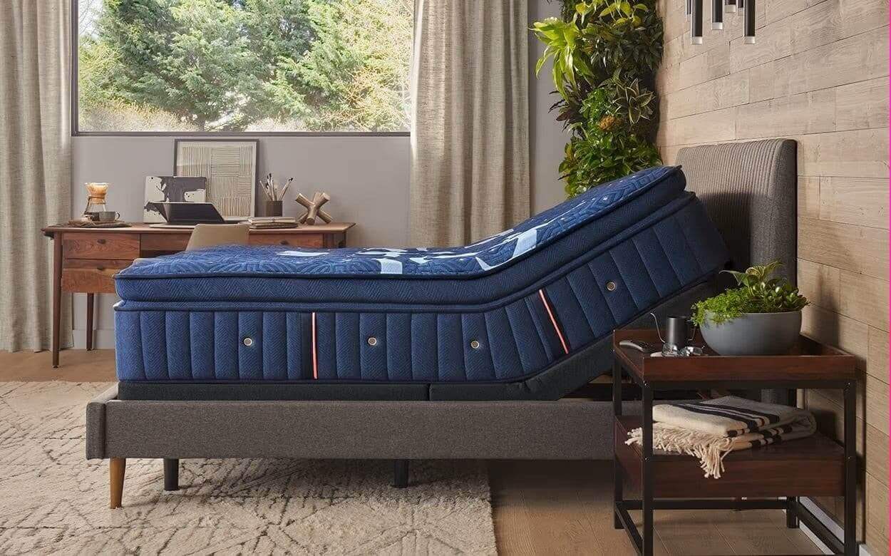Stearns & Foster Lux Estate® Firm Pillow Top Mattress on an adjustable bed in a stylish bedroom setting.
