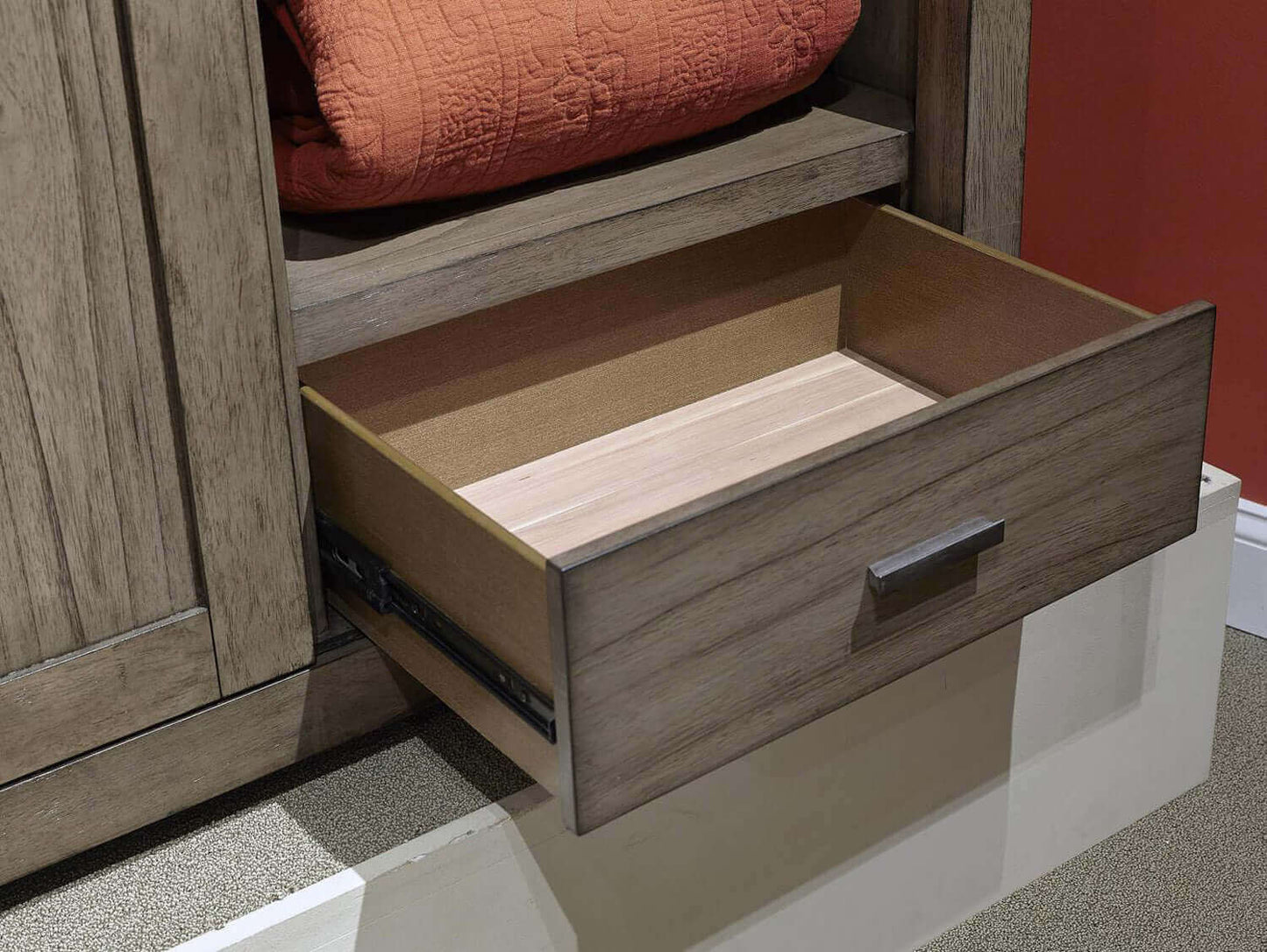 Graystone sliding door chest drawer open, showcasing smooth wood interior and aged bronze hardware.