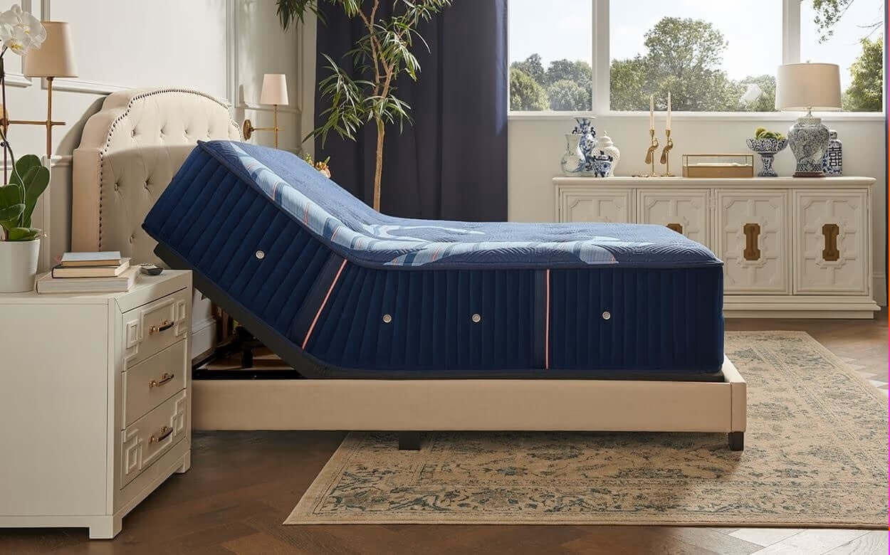 Stearns & Foster Reserve® Medium 16" mattress on adjustable base in elegant bedroom setting with bedside decor.