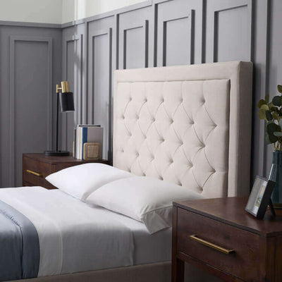 Elegant Malouf Hennessy stone grey headboard with plush tufting, paired with modern wooden nightstands in stylish bedroom setting.