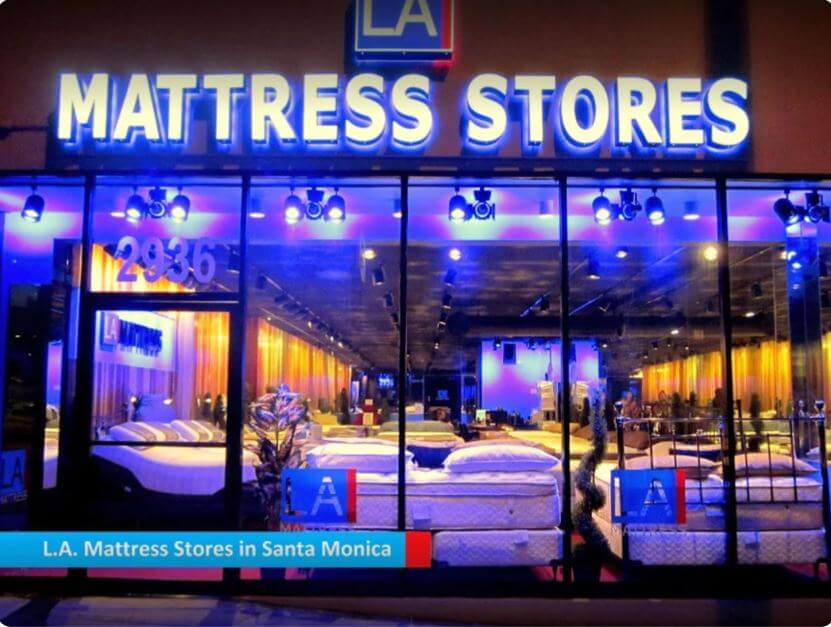 L.A. Mattress Stores in Santa Monica showcasing a bright illuminated storefront filled with mattresses at night.