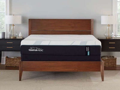 Tempur-Pedic TEMPUR-Adapt 11" Medium Mattress displayed on a wooden bed frame with bedside tables and lamps.