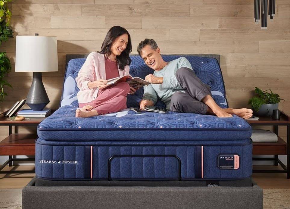 couple enjoying a cozy moment on a Stearns & Foster mattress, showcasing comfort and relaxation in a modern bedroom setting.