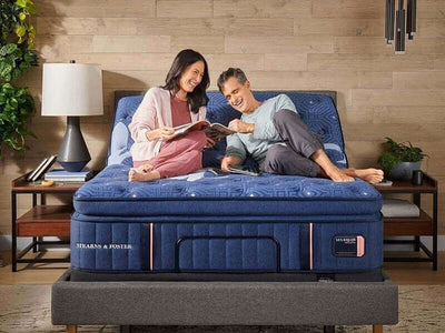 Couple enjoying time together on a Stearns & Foster Lux Estate® Firm Pillow Top Mattress in a stylish bedroom setting.