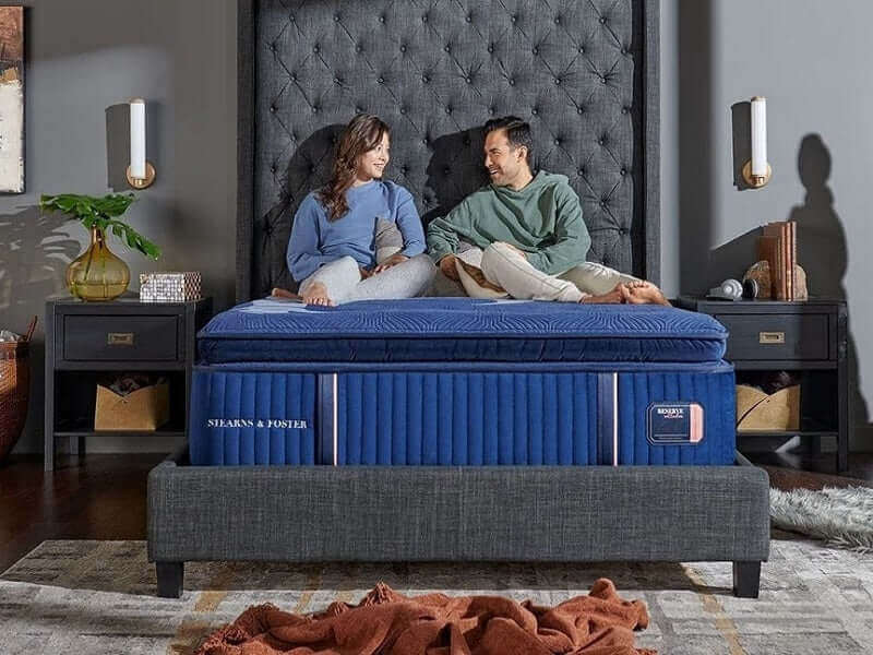 A couple enjoying comfort on the Stearns & Foster Reserve® 17" Soft Pillow Top Mattress in an elegant bedroom setting.