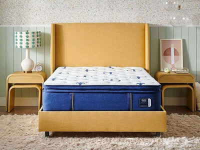 Stearns & Foster Studio Medium Euro Pillow Top mattress on a modern bed with yellow headboard and nightstands.