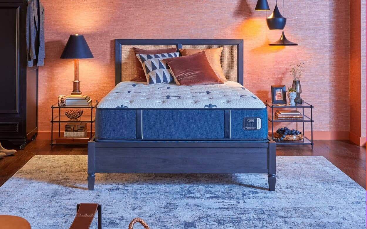 Stearns & Foster Studio Medium 14" Mattress displayed in a stylish bedroom setup with warm lighting and modern decor.