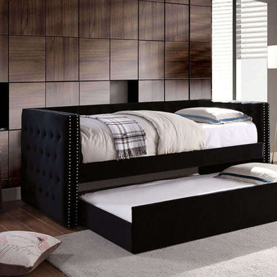 Susanna Black Daybed with button tufting and pull-out trundle in a stylish modern interior setting.
