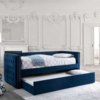 Susanna navy blue daybed with button tufting and pull-out trundle in elegant room setting.