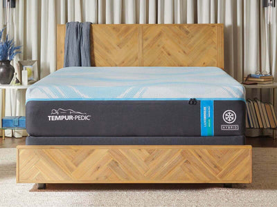 Tempur-Pedic TEMPUR-LuxeBreeze® Medium Hybrid 13" mattress displayed on a modern wooden bed frame.