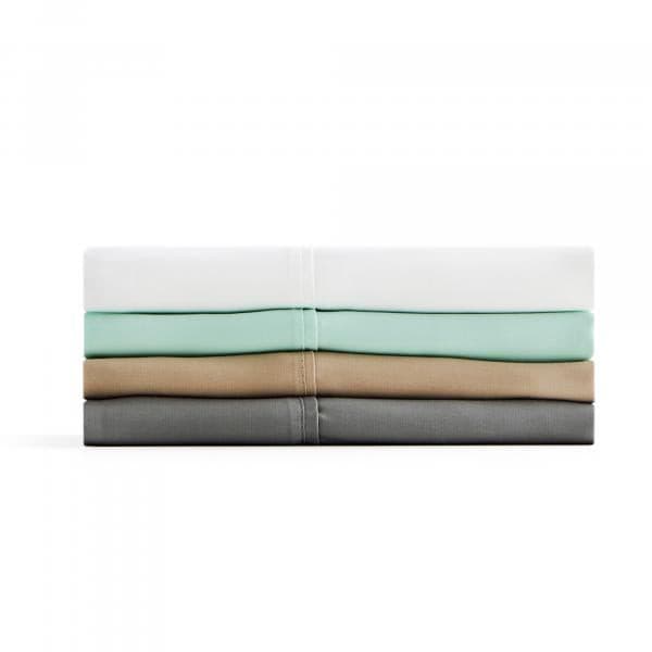Malouf Botanical Tencel Lyocell Sheet Set in various colors stacked neatly. Eco-friendly, soft, and absorbent bedding.