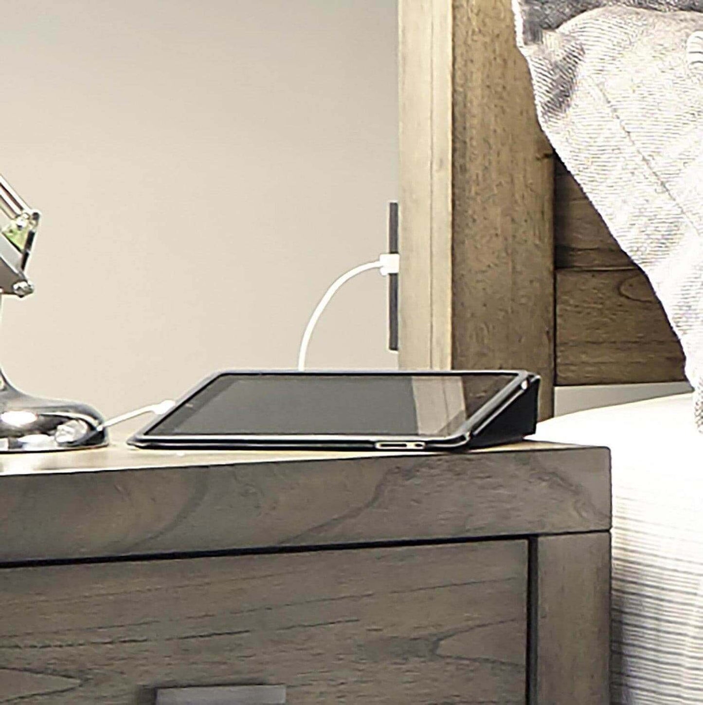 Graystone platform panel bed nightstand with tablet and lamp, showcasing modern loft collection's sleek design.