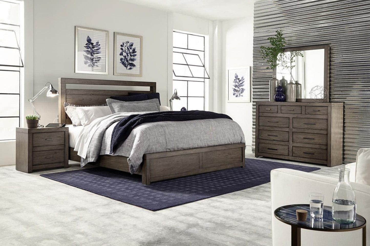 Modern Loft Collection bedroom featuring Graystone nightstand, bed, dresser, and decorative art in a stylish interior setting.