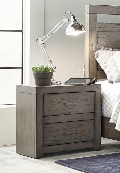Modern Loft Collection Graystone Nightstand with lamp, plant, and digital tablet beside a bed, showcasing elegant design.