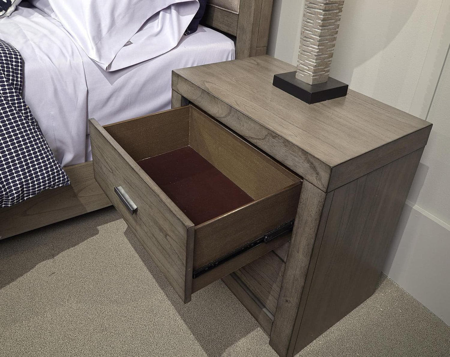 Modern Loft Graystone nightstand with open drawer, showcasing quality craftsmanship and aged bronze hardware.