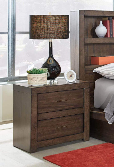 Modern Loft Brownstone nightstand with aged bronze hardware and lamp in a stylish bedroom setting.