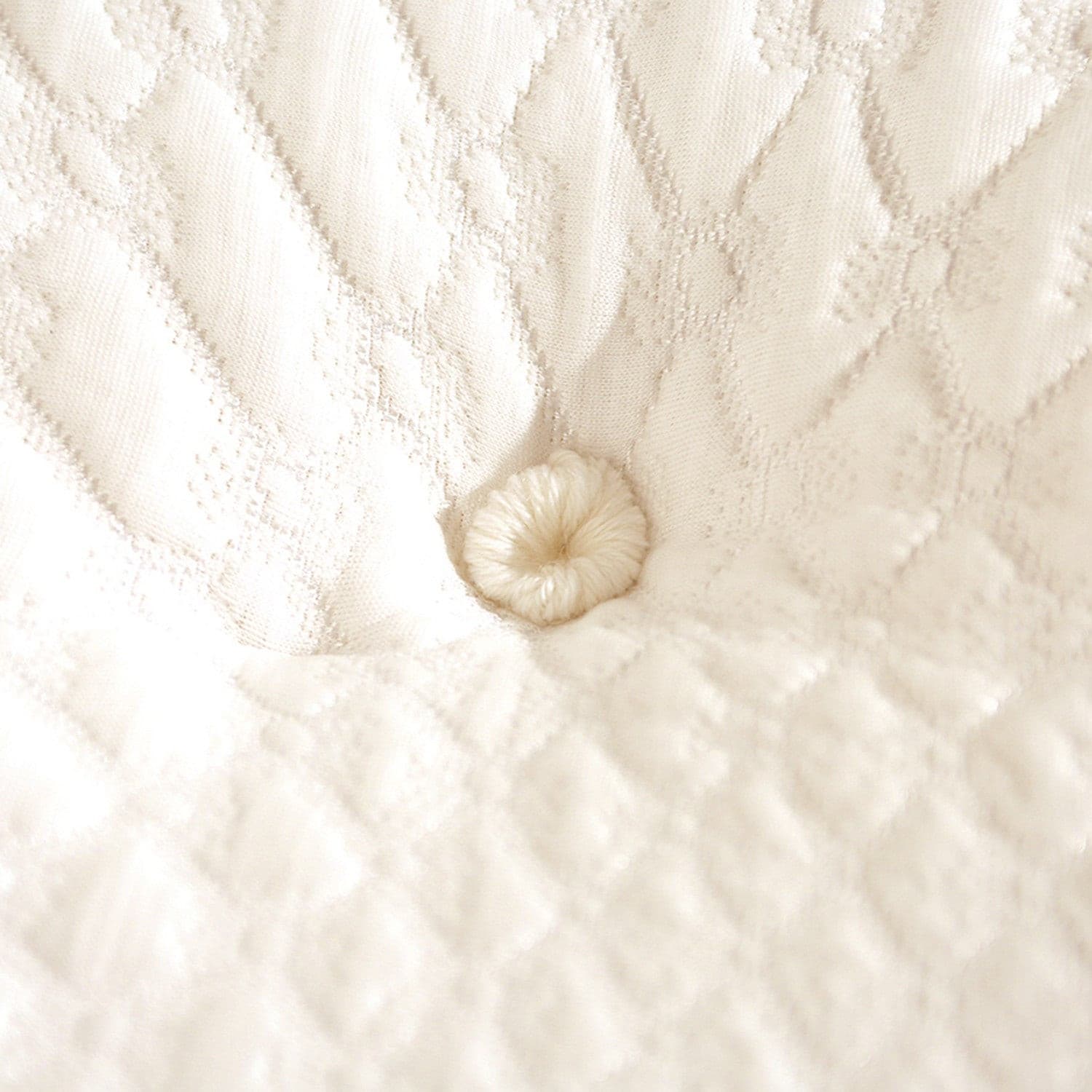 Close-up of a tufted design on a Chattam & Wells Geneva mattress, showcasing its luxurious fabric and craftsmanship.