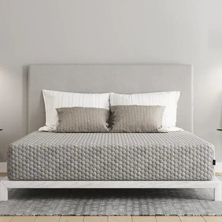 Diamond Align Medium Gel Memory Foam 10" mattress on a platform bed with striped pillows and a gray headboard.