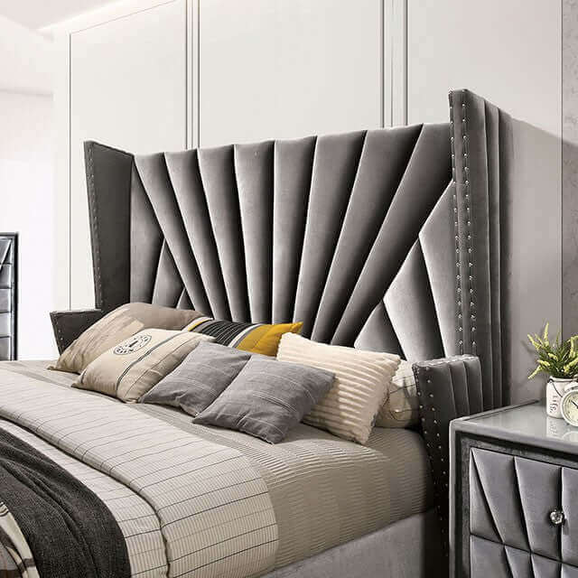 Luxurious gray velvet Art Deco bed with a dramatic tufted headboard and stylish bedding, perfect for a glam bedroom.