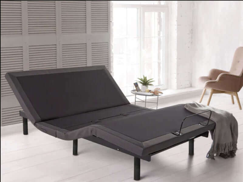 Rize® Clarity II 13" adjustable base in a modern bedroom setting with a cozy throw blanket and natural light.