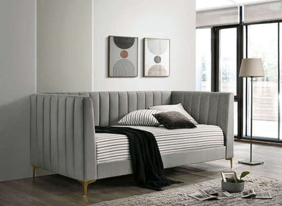 Elegant light gray daybed with tuxedo design, gold legs, and soft flannelette upholstery in a modern living room setting.