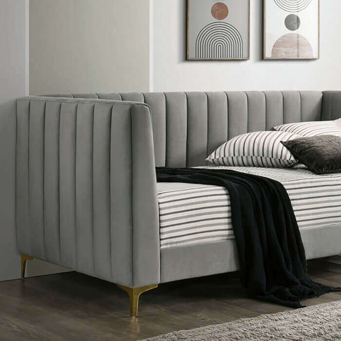 Neoma light gray daybed with tuxedo-inspired design and gold metal legs, showcasing elegant upholstery and comfort.