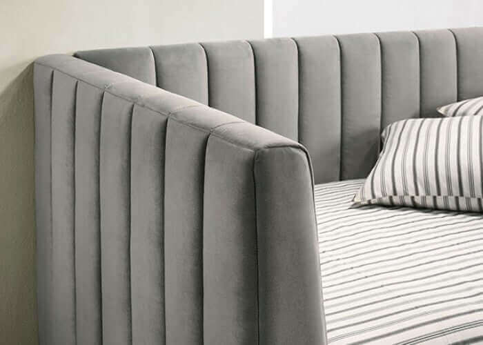 Light gray daybed featuring tuxedo-inspired design and plush flannelette upholstery for comfort and elegance.