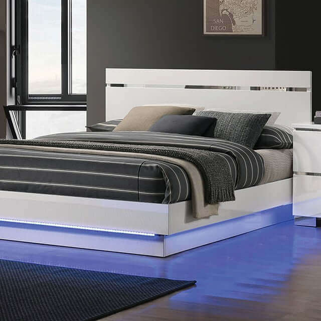 Modern Erlach white gloss platform bed with LED lighting and chrome accents, featuring stylish striped bedding.