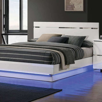 Modern Erlach white gloss platform bed with LED lighting and chrome accents, featuring stylish striped bedding.
