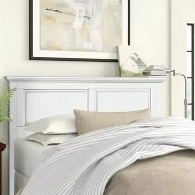 Cottage style white headboard in a cozy bedroom setting with soft bedding and modern decor.