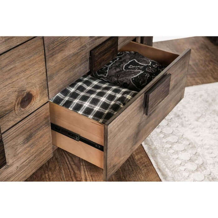 Open drawer of Janeiro Rustic Chest showcasing neatly folded blankets in a stylish wooden bedroom setting.