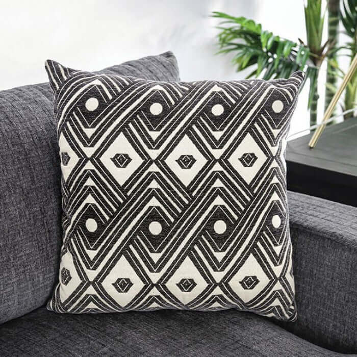 Decorative geometric accent pillow on Kaylee Gray Sectional Sofa, adding style and comfort to your living space.