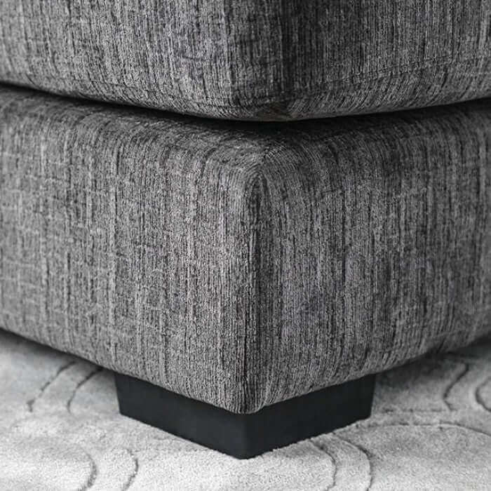 Close-up of Kaylee Gray Sectional Sofa's plush fabric and sturdy bracket feet, showcasing its modern design and comfort.