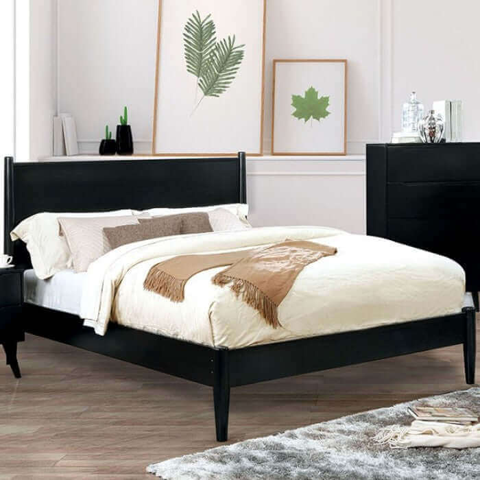 Lennart Black Platform Bed featuring a modern design with flared legs and a cozy bedding arrangement in a styled room.