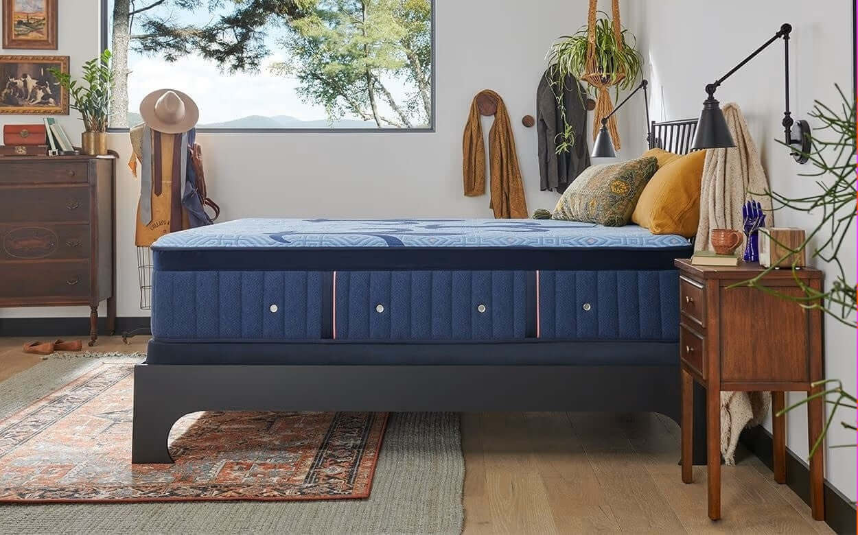 Stearns & Foster Lux Hybrid Medium 14" mattress displayed in a stylish bedroom setting with wooden furniture and decor.