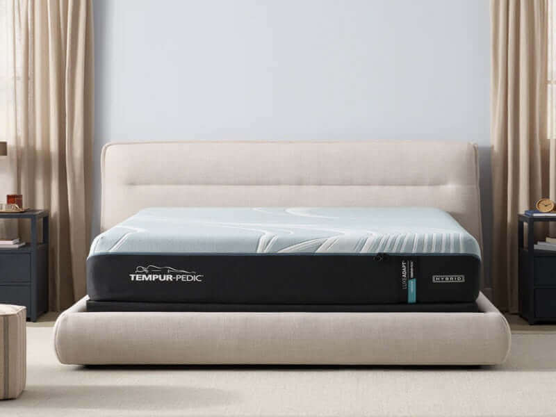 Tempur-Pedic TEMPUR-LuxeAdapt® 13" Medium Hybrid Mattress on a stylish bed frame in a cozy bedroom setting.