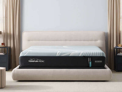 Tempur-Pedic TEMPUR-LuxeAdapt® 13" Medium Hybrid Mattress on a stylish bed frame in a cozy bedroom setting.