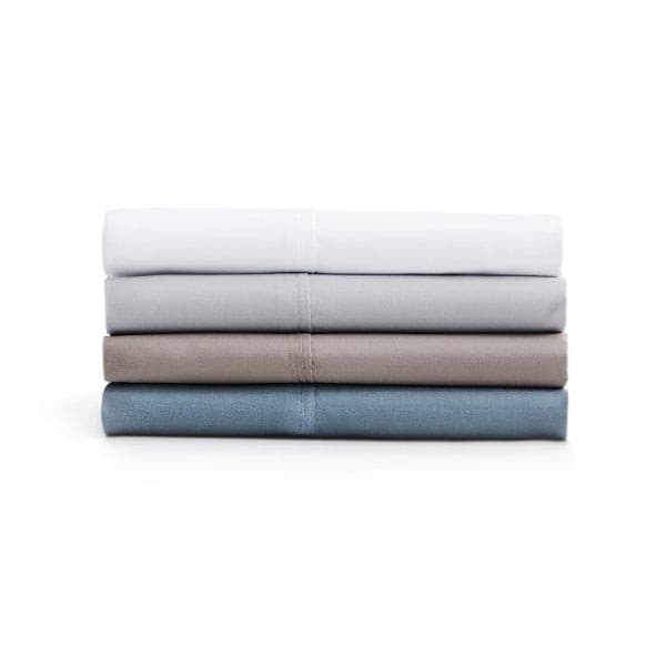 Stack of Malouf Driftwood microfiber pillowcases in white, grey, taupe, and blue, showcasing soft and cozy textures.
