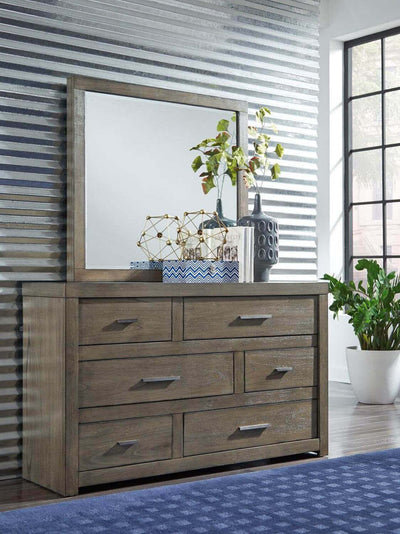 Modern Loft Collection graystone dresser with mirror, aged bronze hardware, and stylish decor accents in contemporary home setting.