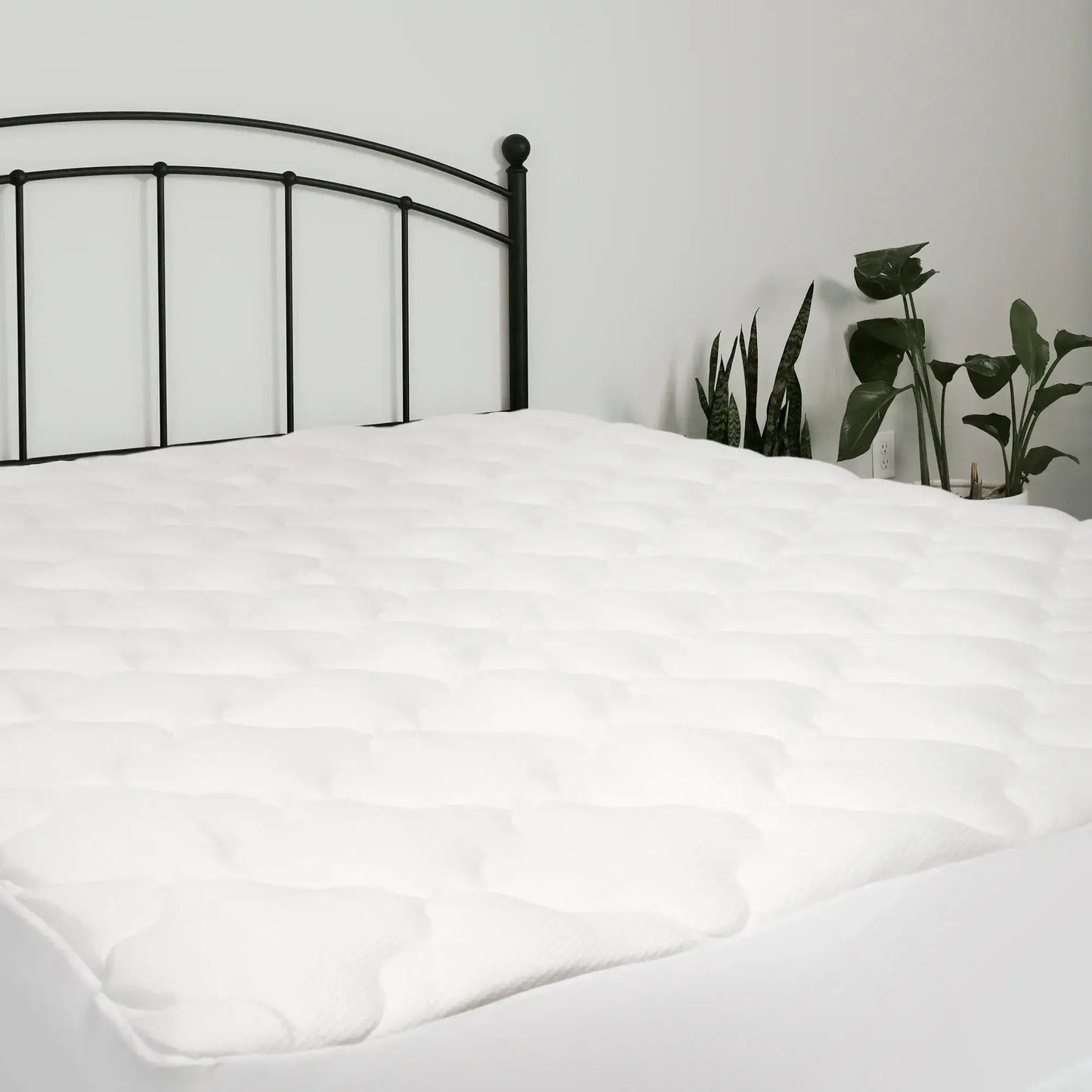 Rayon bamboo mattress pad on a bed, showcasing its plush texture and cooling design for optimal comfort.