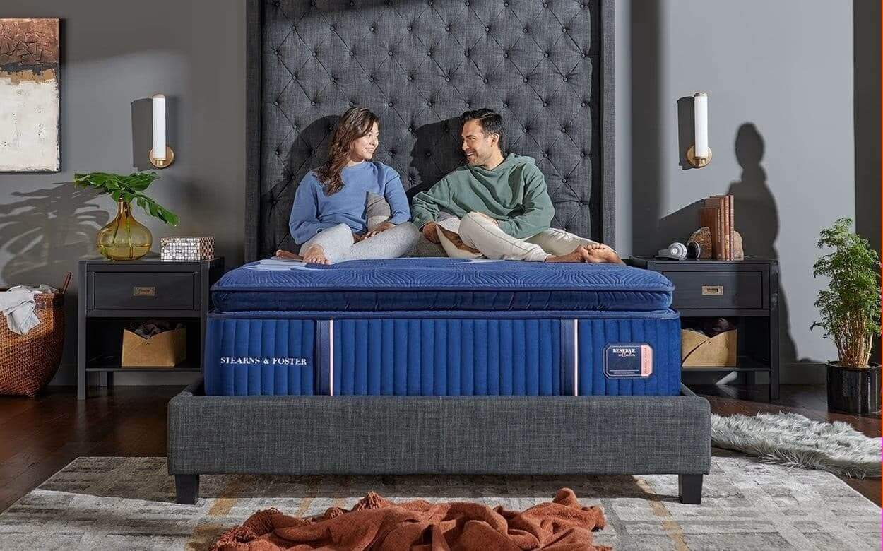 couple enjoying comfort on a stylish mattress in a modern bedroom, showcasing cozy design elements and decor.
