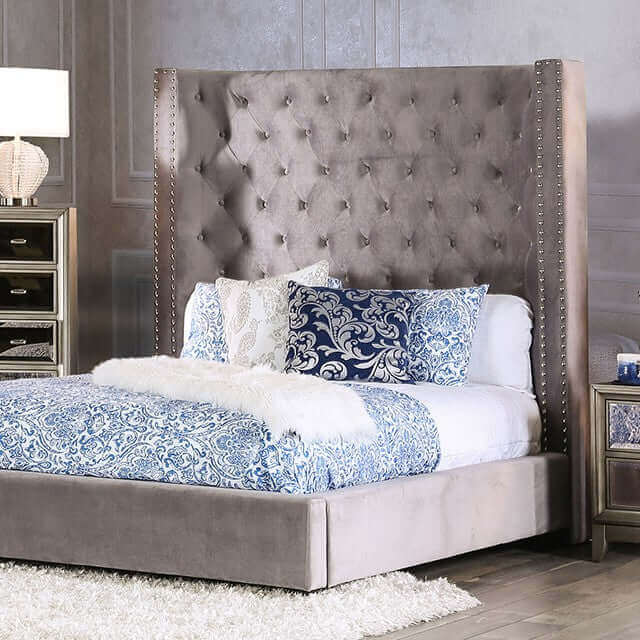 Rosabelle tufted wingback bed with diamond pattern headboard and nailhead trim, featuring blue and white bedding.