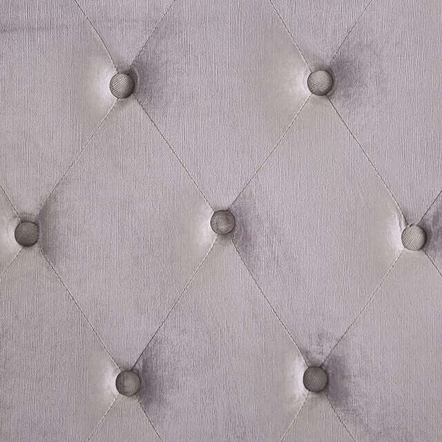 Close-up of the Rosabelle tufted fabric bed headboard with diamond pattern and button details in soft grey.