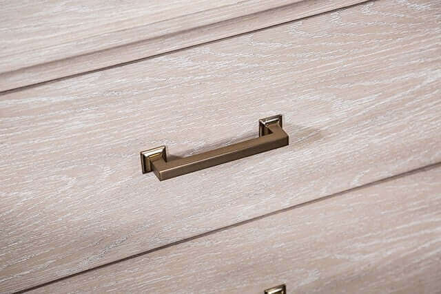 Close-up of the Sandnes Light Oak Storage Bed Frame's stylish drawer handle in a light oak finish.